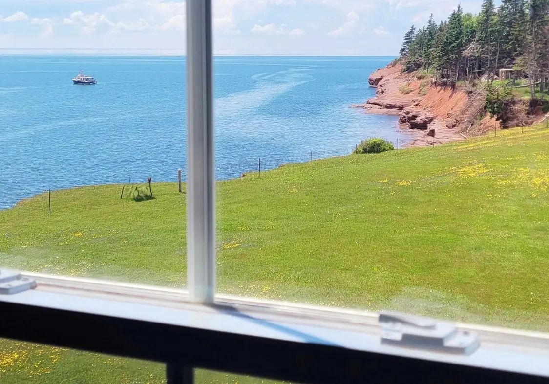 The lawn and the ocean seen through the common room windows