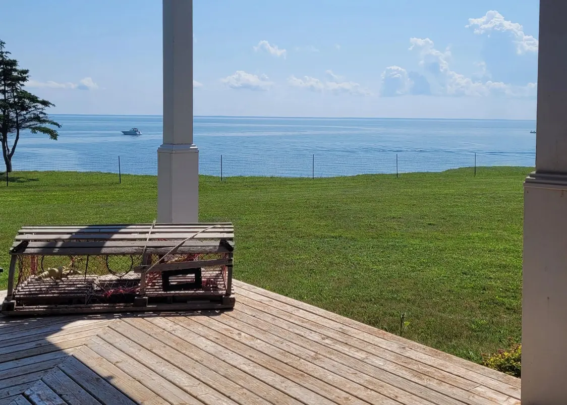 The deck with its lobster-trap table, the ocean beyond