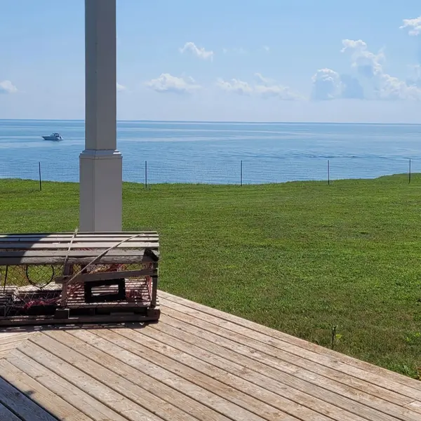 The deck and lobster-trap table with the strait beyond, in July