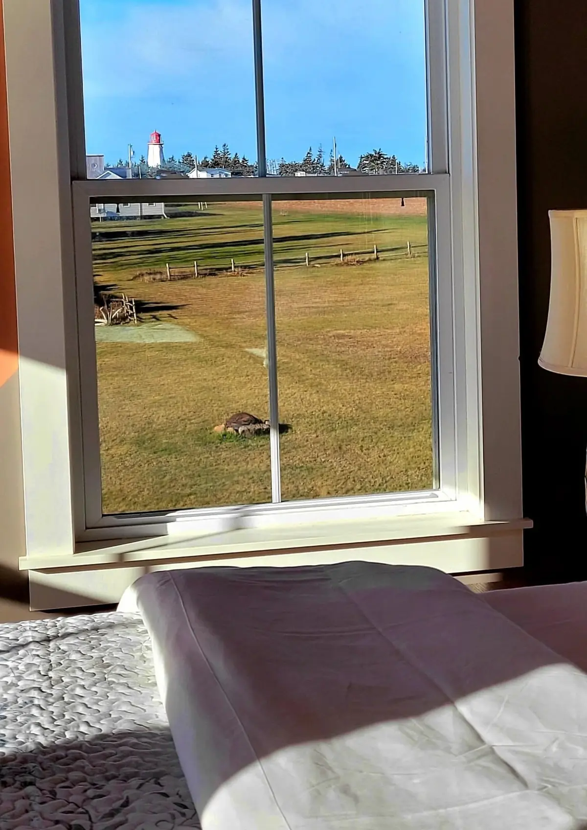 Window seat with a deep sill, the field and the strait beyond